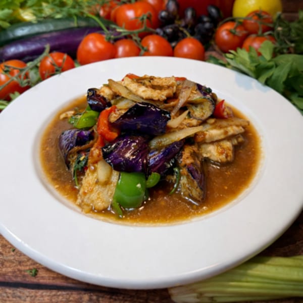 Seabasil Thai & Seafood's stir-fried chicken with eggplant, bell peppers, and onions in a savory sauce.